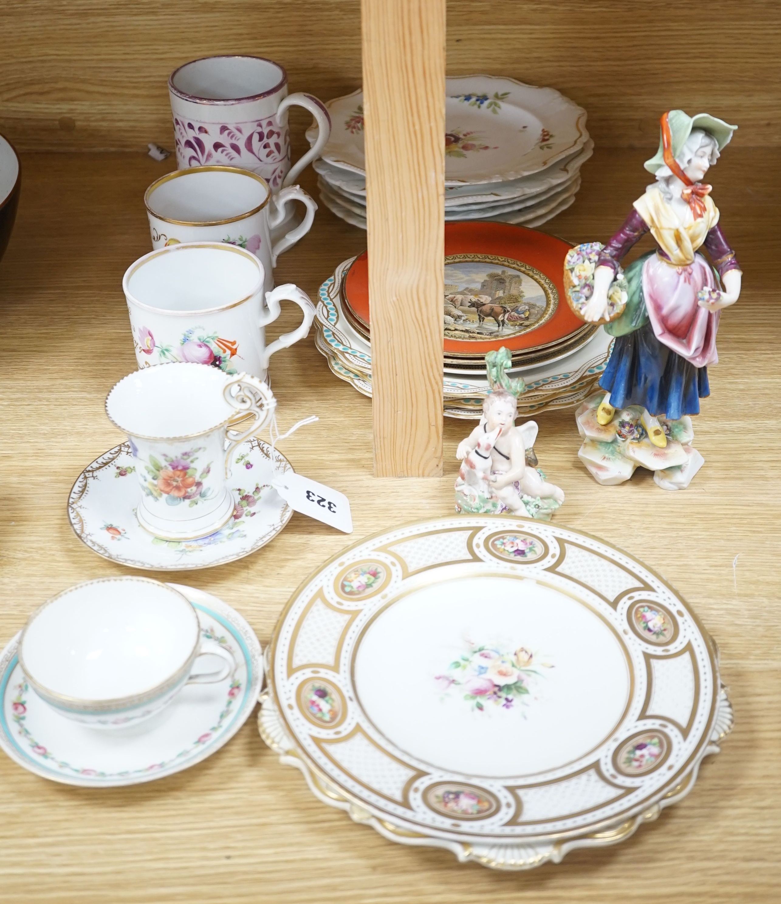 A collection of 19th century English porcelain plates and mugs and a Derby Cupid group, c.1775